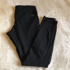 Black Nike Dri-Fit leggings with mesh calf detail